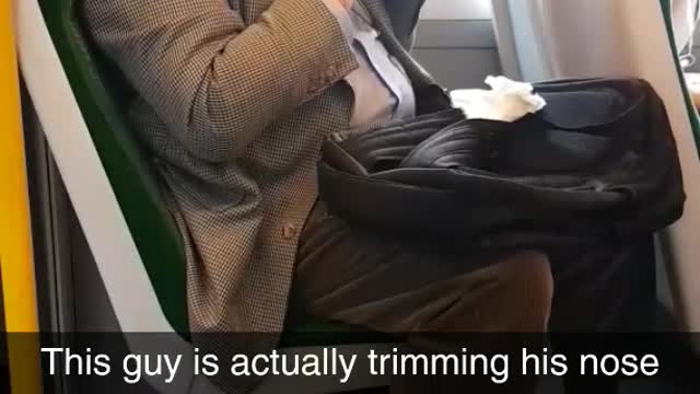 Man trimming nose hairs on train suit