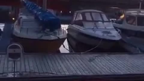 Guy jumping into boat