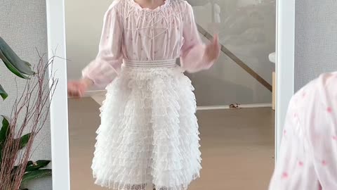 cute baby jumping in front of the mirror in cute going out outfit