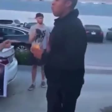Man eats burger in front of vegan protesters