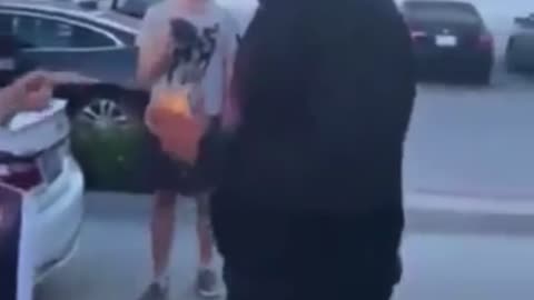 Man eats burger in front of vegan protesters