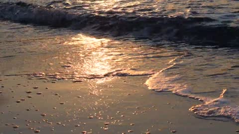 Beach waves at sunset