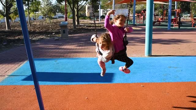 Noya and Shir play in a playground