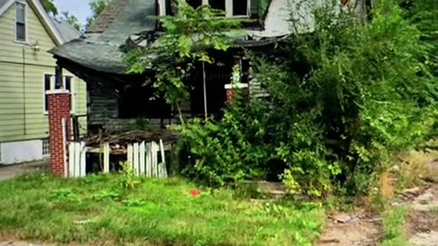 2009: A Family sits on their porch in Detroit, Michigan 3