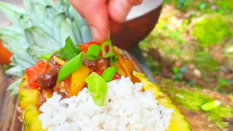 Meat with pineapple in the forest on a fire