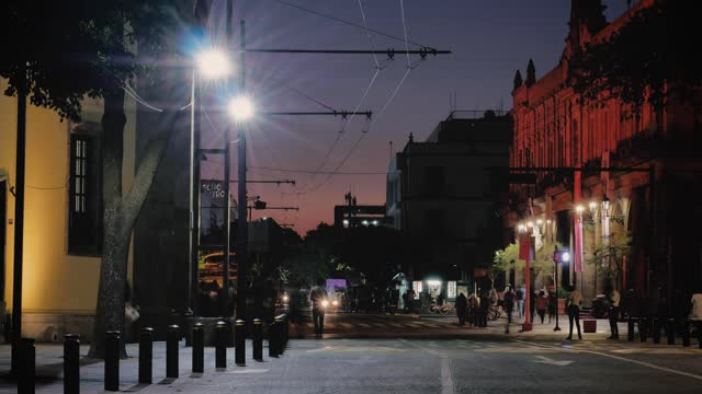 City street with trolleybus at night