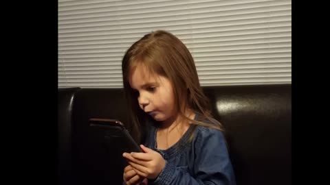 Funny little girl talking with Siri