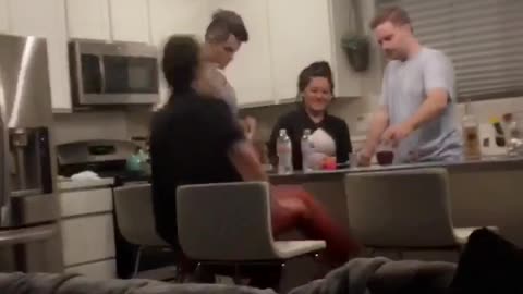 Black shirt misses chair when sits down