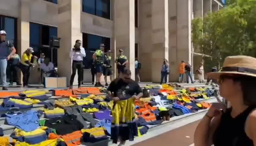 Patriots in Australia laying down their work uniforms on the steps of parliament