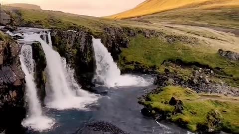 Kirkjufels waterfall in Iceland under a straw hat, beautiful sunset with a touch of sunset