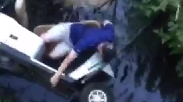 Purple blue shirt golf cart in water man down