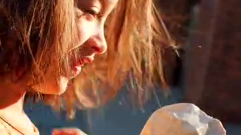 Girl Wearing an Orange Dress While Eating Ice Cream