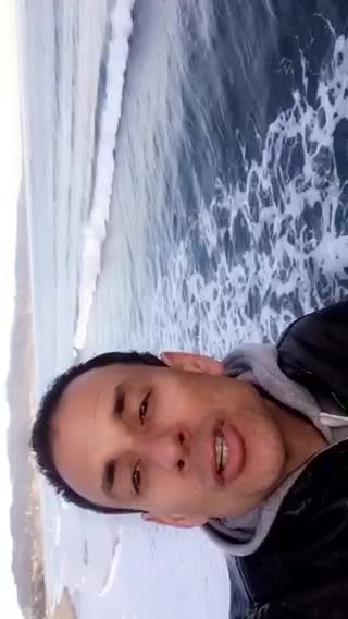 Guy talking to camera at the beach