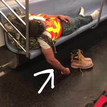 Hard day at work construction worker shoes off sleeping subway