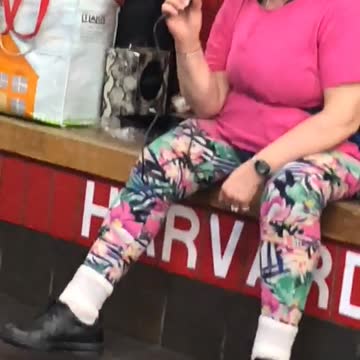 Lady pink sitting on bench subway singing