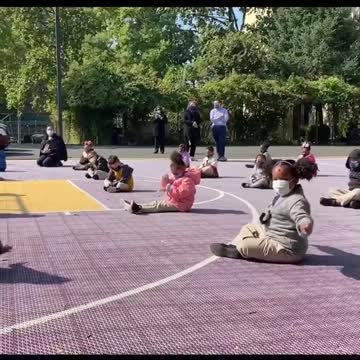 Children turn into conductors during outdoor symphony at school