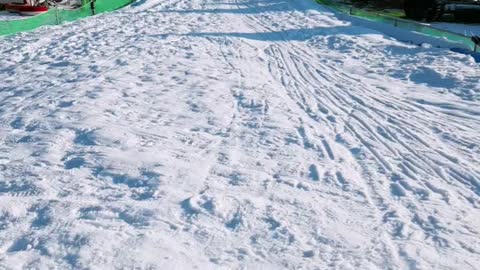 A sledding mother and a baby.