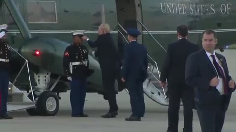 President Trump picks up the hat on the ground