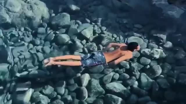 The water is so transparent that I don't even know if he is on the surface or bottom.