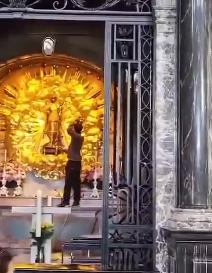 (Illegals a problem everywhere) Switzerland: Afghanistan Asylum seeker puts on Black Madonna crown in front of praying Christians at the Einsiedeln Abbey Church