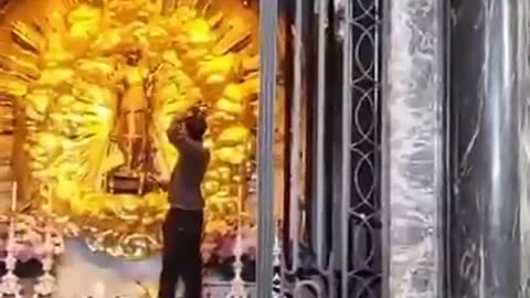 (Illegals a problem everywhere) Switzerland: Afghanistan Asylum seeker puts on Black Madonna crown in front of praying Christians at the Einsiedeln Abbey Church