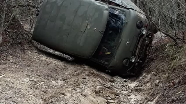 Utility Vehicle Gets Back Up After Being Stuck in a Rut