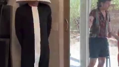 Man dressed as a lamp scares his friend