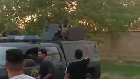 Security forces are handing out bottles of water to protesters