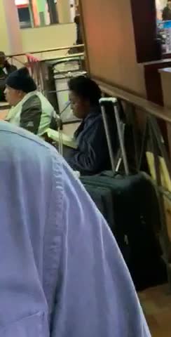 Woman shaking while reading at train station