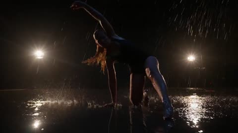 Woman dancing under the rain