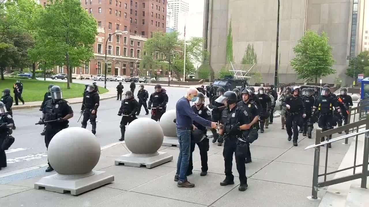 Old man pushed by cops to the ground