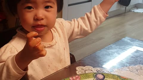 The baby is pretending to be pretty.