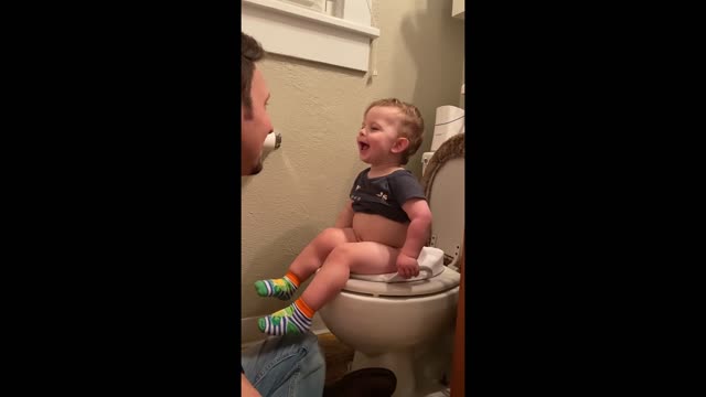 Cute baby fun talk with daddy