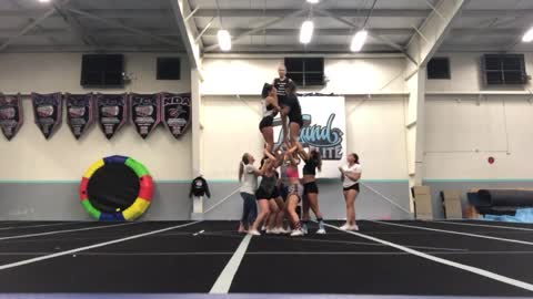 Cheer practice pyramid girl on top falls