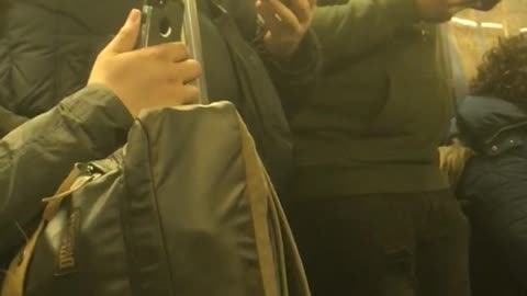 Man chews on and eats his earphone standing on subway