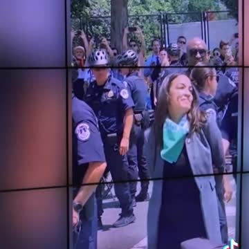 AOC FAKES being in handcuffs.