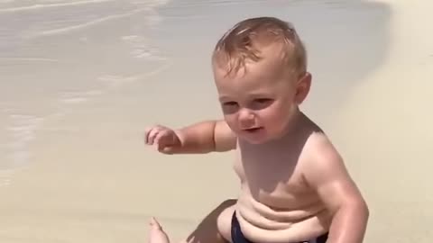 Cute beach baby scared of waves