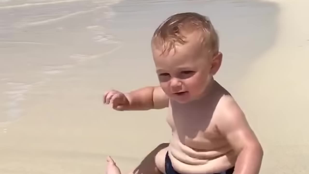 Cute beach baby scared of waves