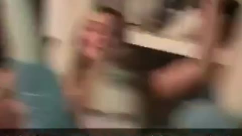 Party guy sits in corner on laptop