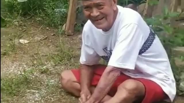 cute grandfather catching chicken