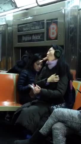 Woman suck brown popsicle no hands on subway