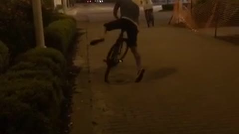 Night time biker rides into plastic fence