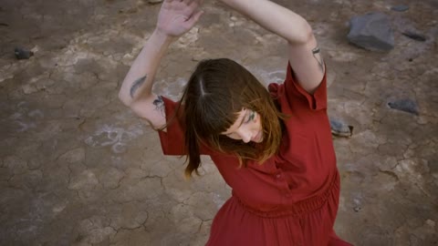 Woman stretching her body sitting on the ground in a desert