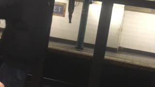 Guy skips and dances next to subway train platform edge