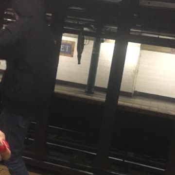 Guy skips and dances next to subway train platform edge