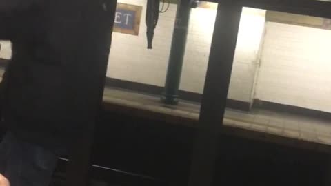 Guy skips and dances next to subway train platform edge