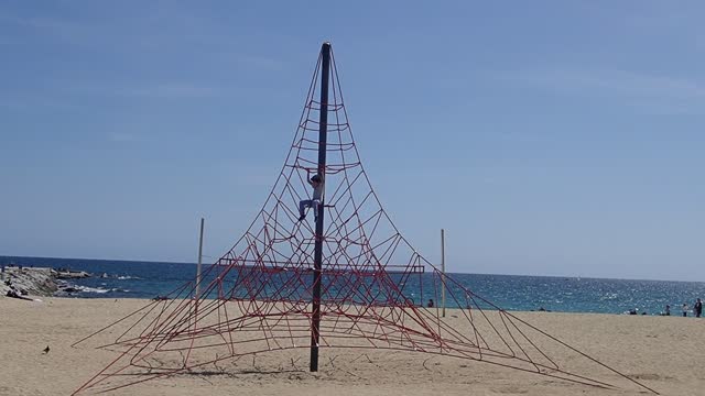 Kid Playing Besides A Sea Beach