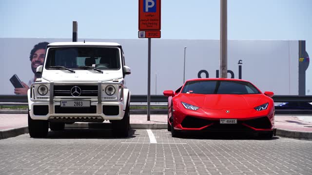 Lamborghini And Mercedes-Benz G-Wagen Standing Side By Side