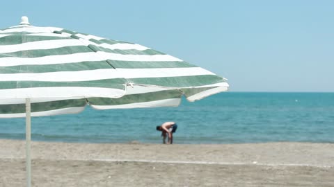 Father and son in the distance on the seashore