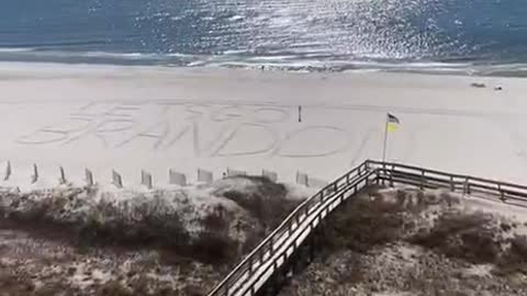 Writing in the sand "Let's Go Brandon"